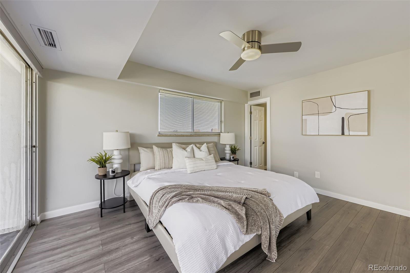 1121 Albion Street, Unit 709 Denver, CO 80220 - Photo 10 of 24 a bedroom with bed and a chandelier