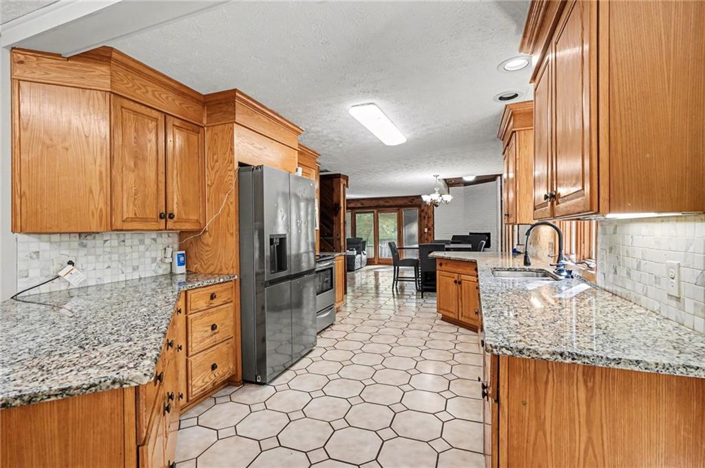 2530 Rockbridge Road Northwest Conyers, GA 30012 - Photo 12 of 45 a kitchen with stainless steel appliances granite countertop a sink stove and refrigerator