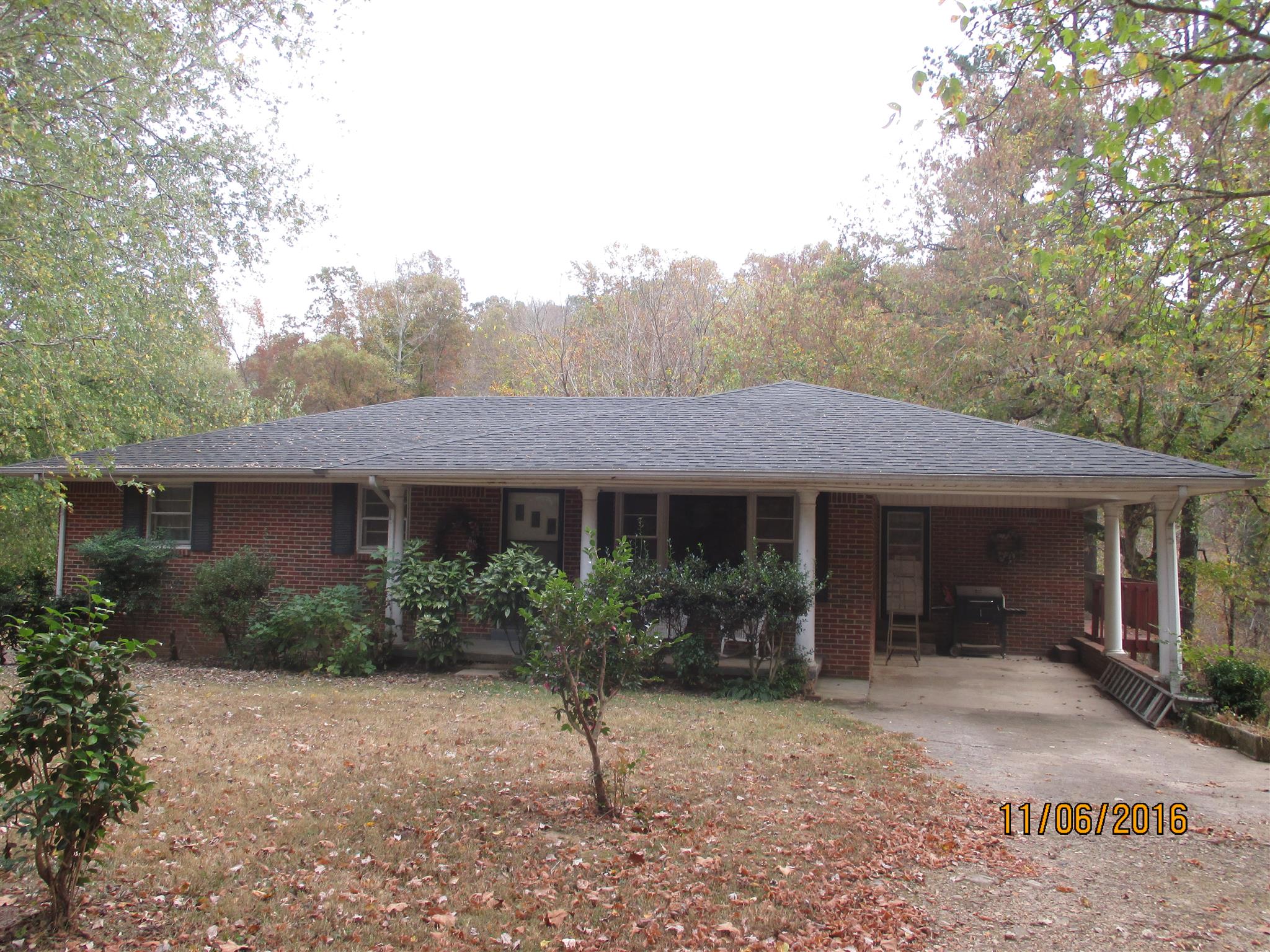 2409 Shores Road Goodspring, TN 38460 - Photo 1 of 21 a front view of house with yard and trees around
