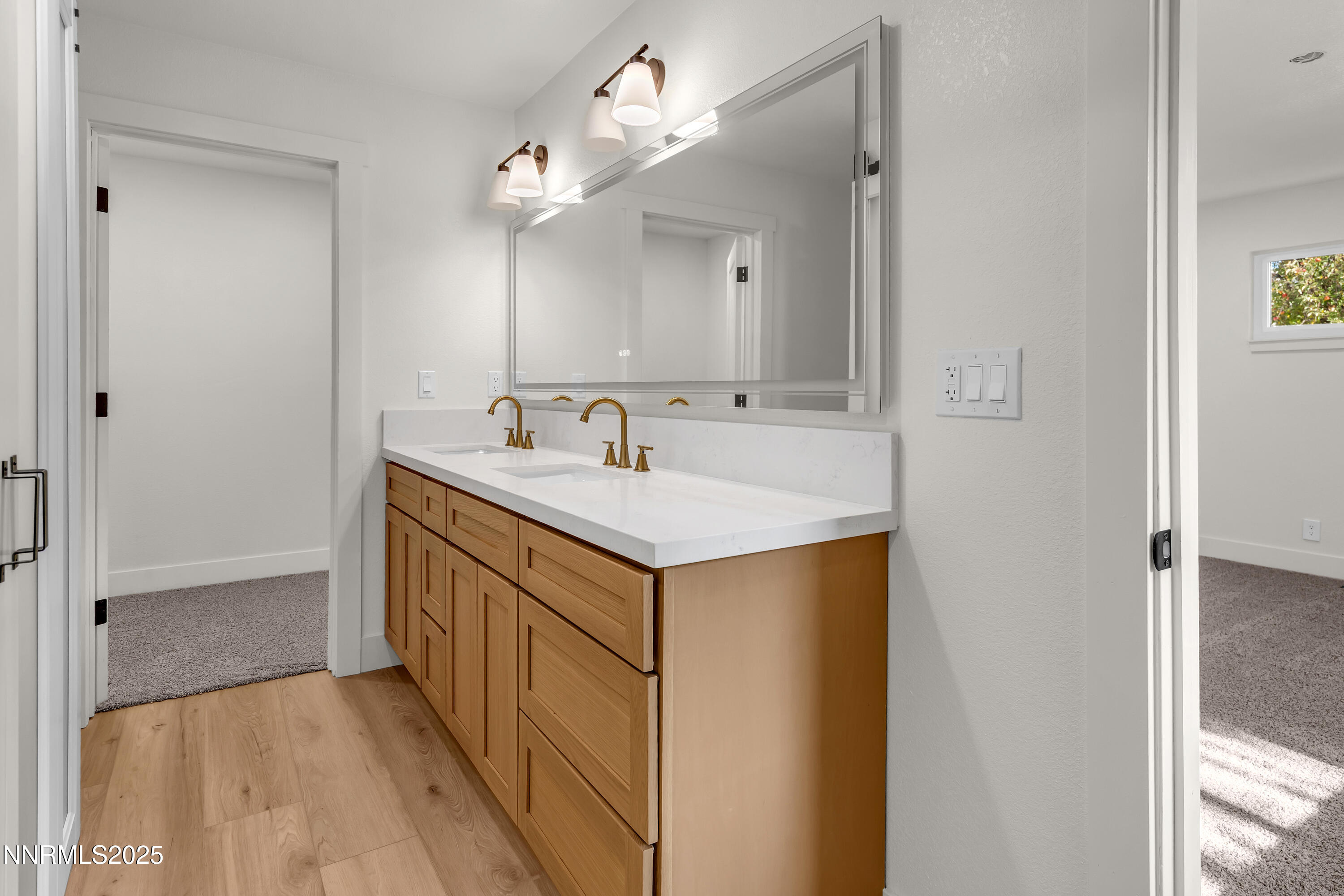 650 John Fremont Drive Reno, NV 89509 - Photo 22 of 37 a bathroom with a sink a mirror and a vanity
