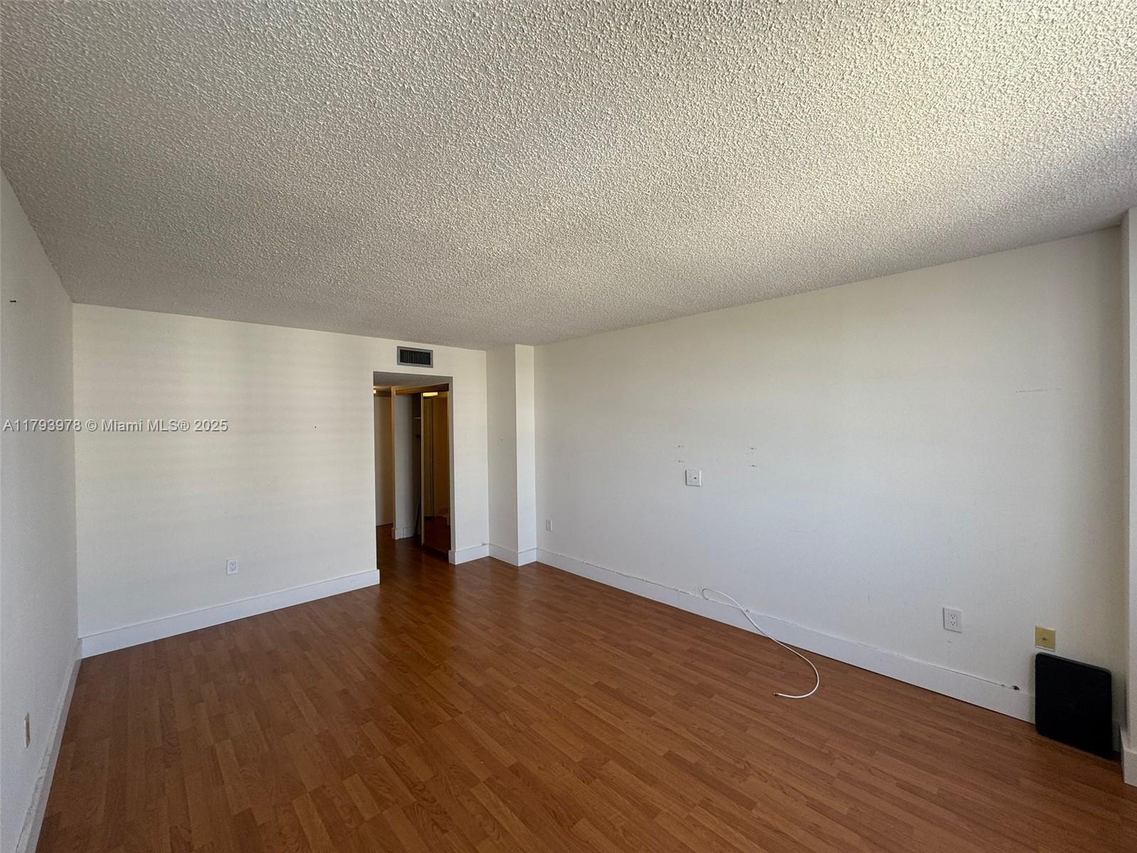2851 Northeast 183rd Street, Unit 1408E Aventura, FL 33160 - Photo 12 of 24 a view of an empty room with wooden floor