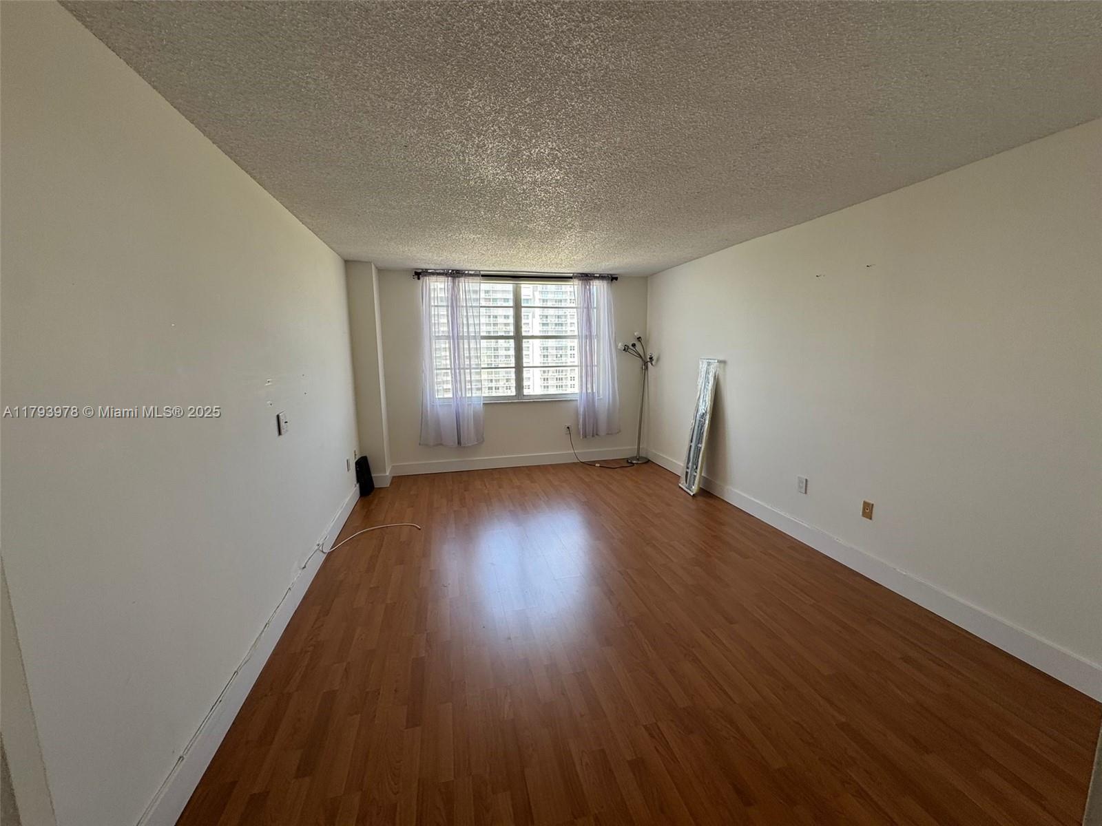 2851 Northeast 183rd Street, Unit 1408E Aventura, FL 33160 - Photo 14 of 24 wooden floor in an empty room with a window