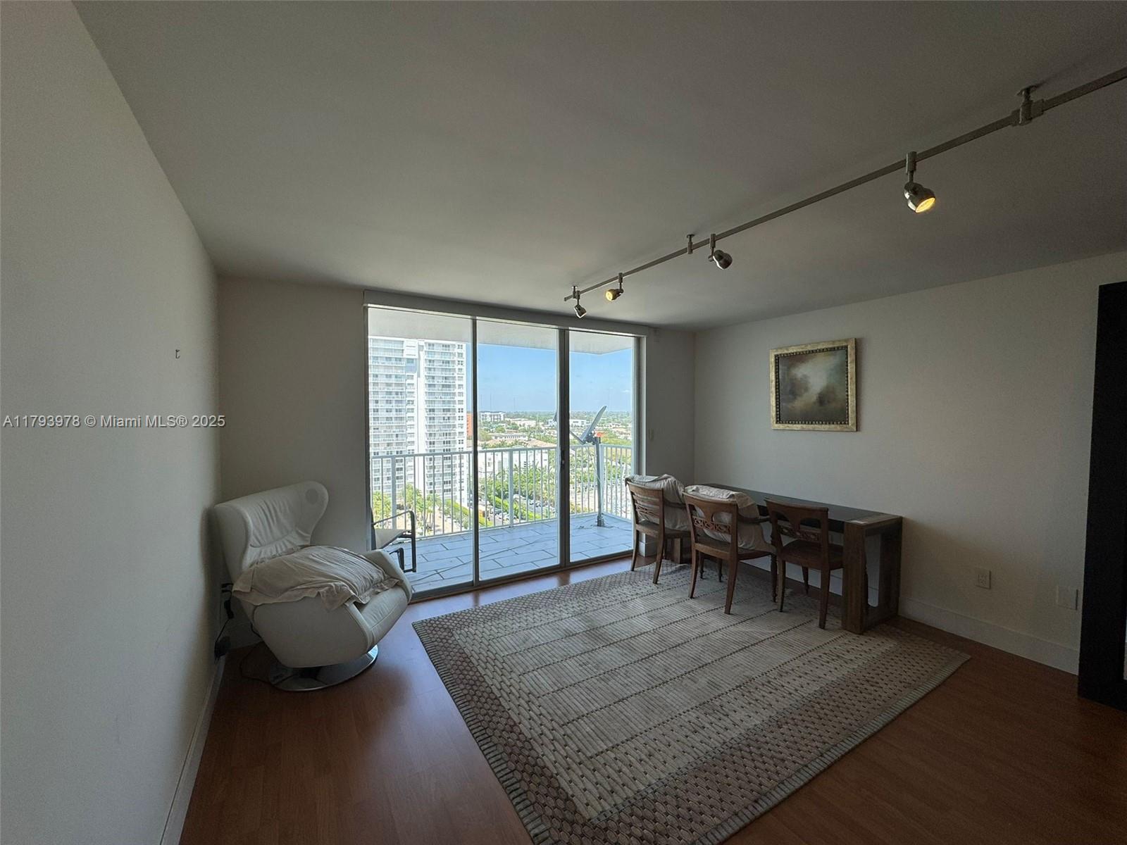 2851 Northeast 183rd Street, Unit 1408E Aventura, FL 33160 - Photo 3 of 24 a living room with furniture and a floor to ceiling window