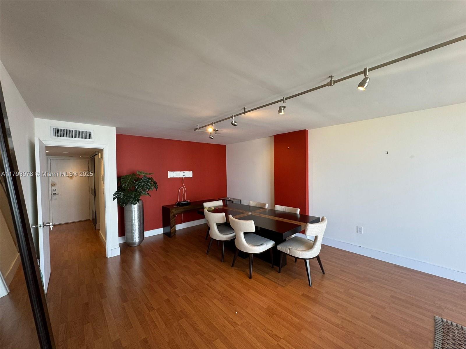 2851 Northeast 183rd Street, Unit 1408E Aventura, FL 33160 - Photo 7 of 24 a dining room with furniture and wooden floor