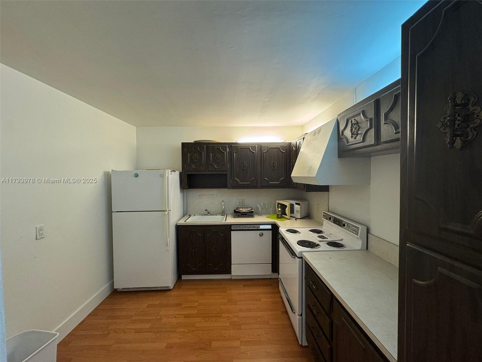 2851 Northeast 183rd Street, Unit 1408E Aventura, FL 33160 - Photo 8 of 24 a kitchen with stainless steel appliances granite countertop a sink stove and refrigerator