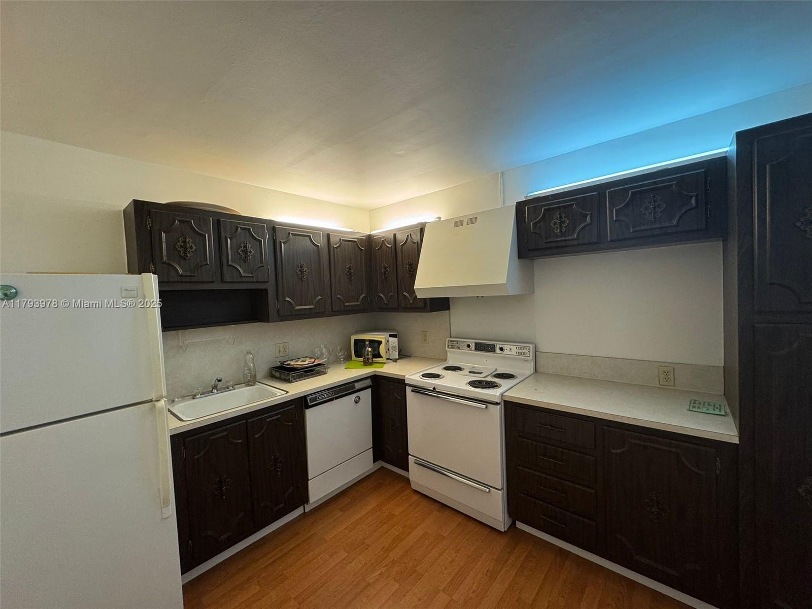 2851 Northeast 183rd Street, Unit 1408E Aventura, FL 33160 - Photo 9 of 24 a kitchen with a sink a stove and refrigerator