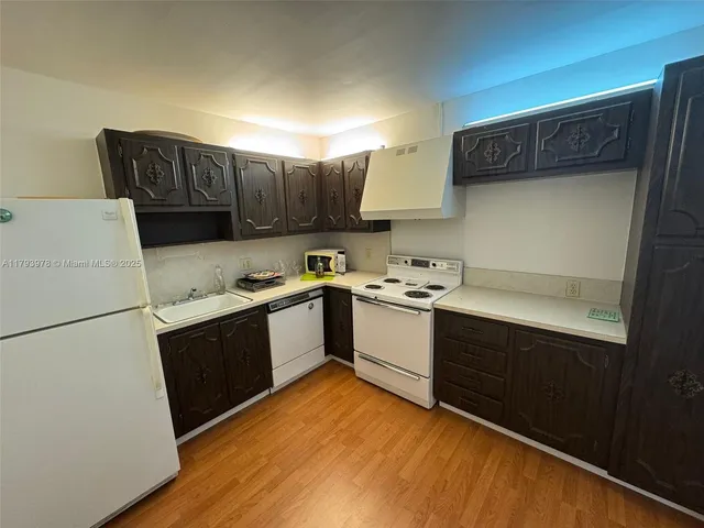 a kitchen with stainless steel appliances granite countertop a refrigerator sink and cabinets