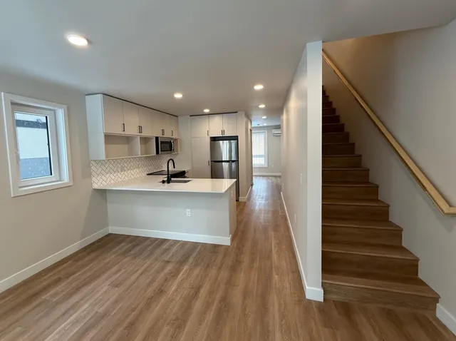 a view of kitchen with sink microwave and refrigerator