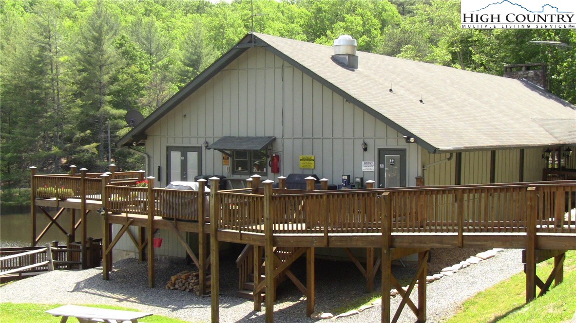 431 Roaring Ridge Road Deep Gap, NC 28618 - Photo 36 of 39 a view of a patio with table and chairs with wooden floor and fence