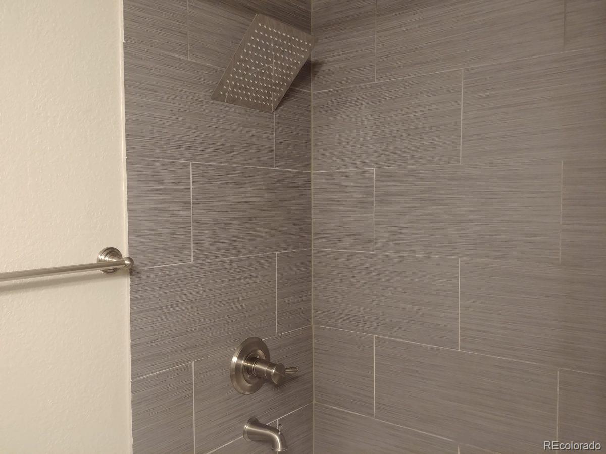 2918 Ames Street Wheat Ridge, CO 80214 - Photo 12 of 19 a bathroom with a shower