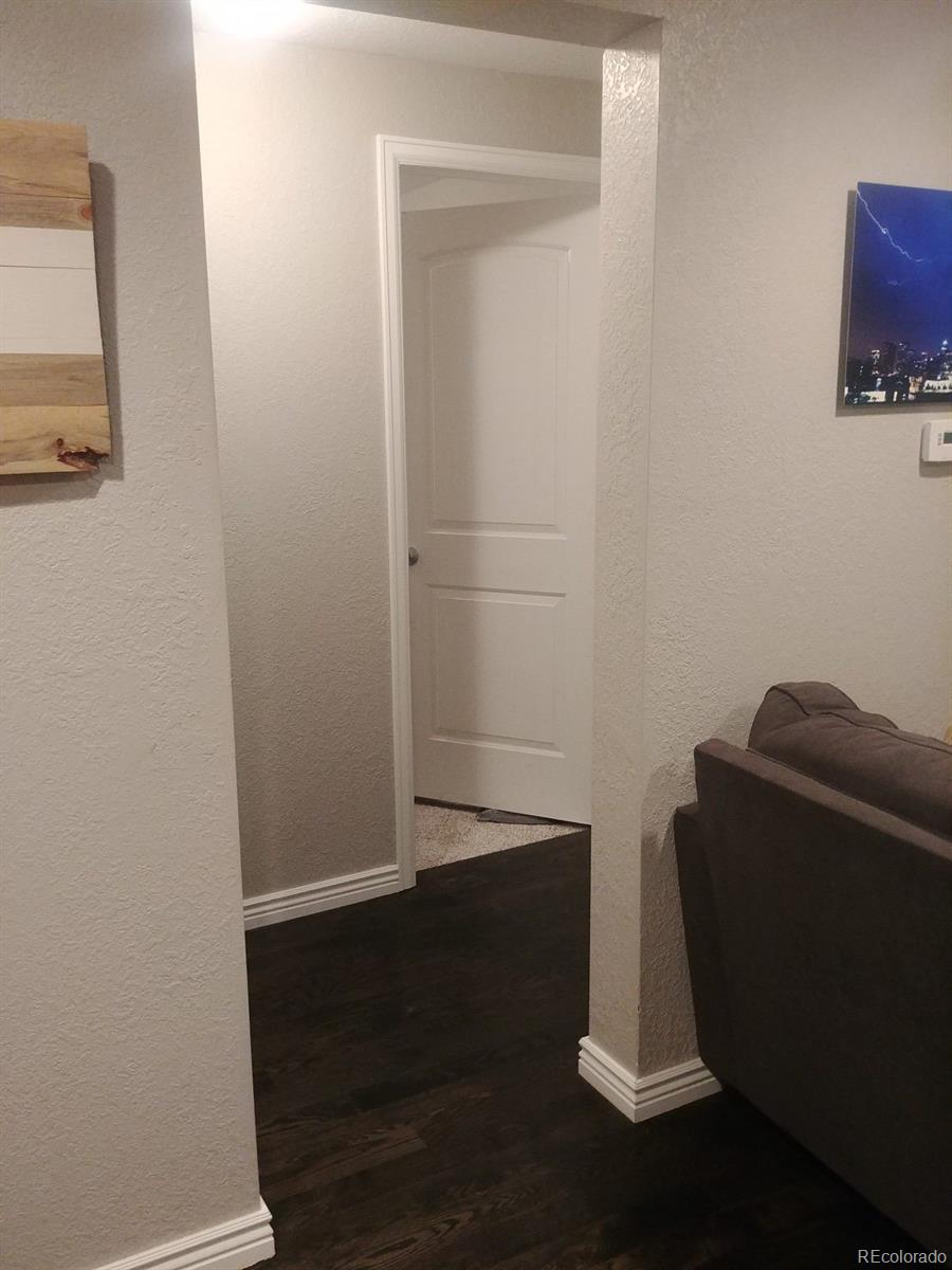 2918 Ames Street Wheat Ridge, CO 80214 - Photo 13 of 19 a room with a window and wooden floor