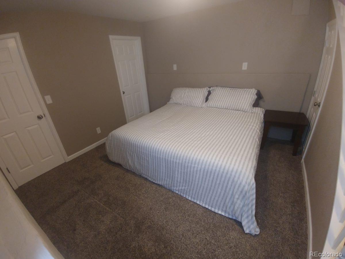 2918 Ames Street Wheat Ridge, CO 80214 - Photo 18 of 19 a bedroom with a bed and a window