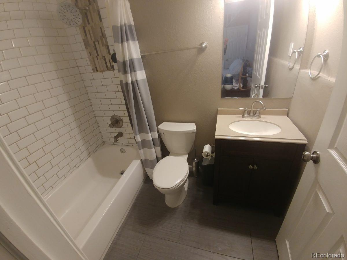 2918 Ames Street Wheat Ridge, CO 80214 - Photo 19 of 19 a bathroom with a sink toilet and shower