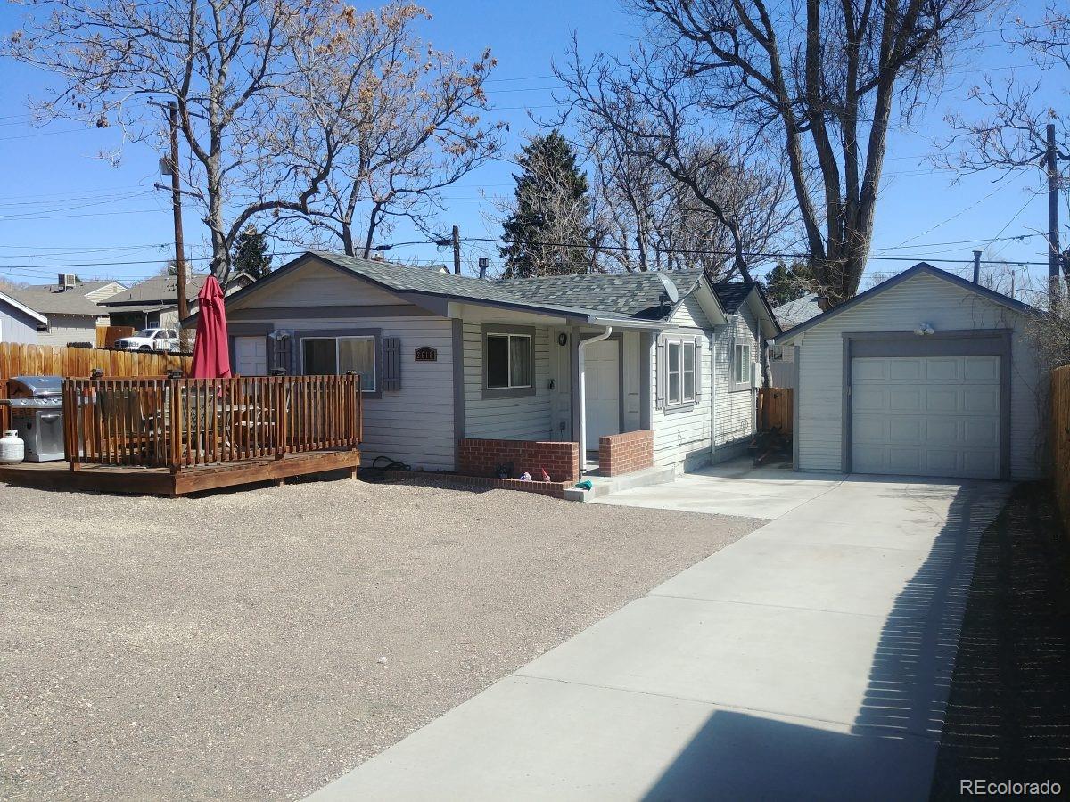 2918 Ames Street Wheat Ridge, CO 80214 - Photo 2 of 19 a front view of a house with a yard and garage