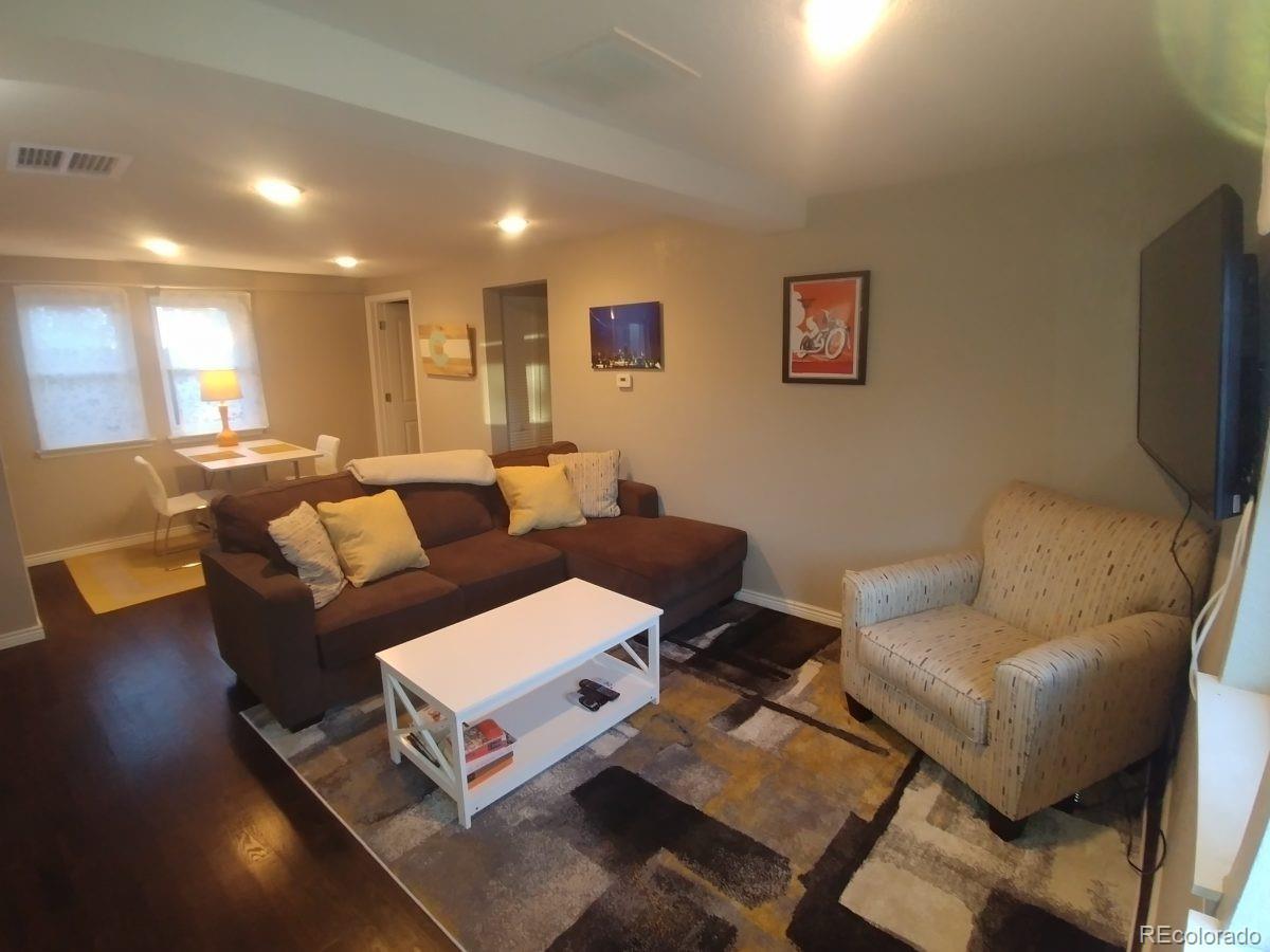 2918 Ames Street Wheat Ridge, CO 80214 - Photo 6 of 19 a living room with couches and a flat screen tv