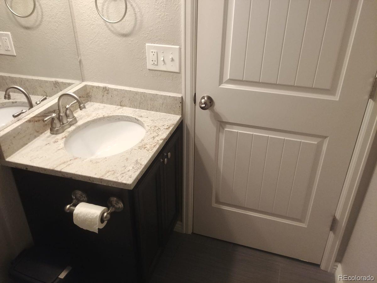 2918 Ames Street Wheat Ridge, CO 80214 - Photo 10 of 19 a bathroom with a sink and vanity