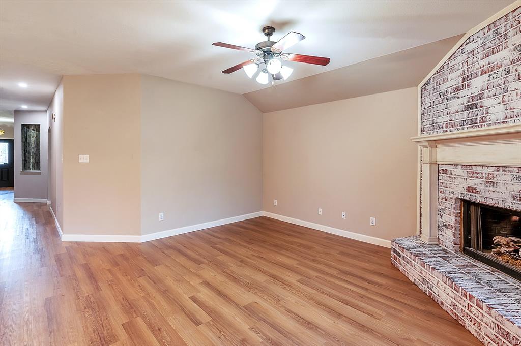 1070 Shepard Lane Lavon, TX 75166 - Photo 7 of 29 a view of an empty room with wooden floor a fireplace