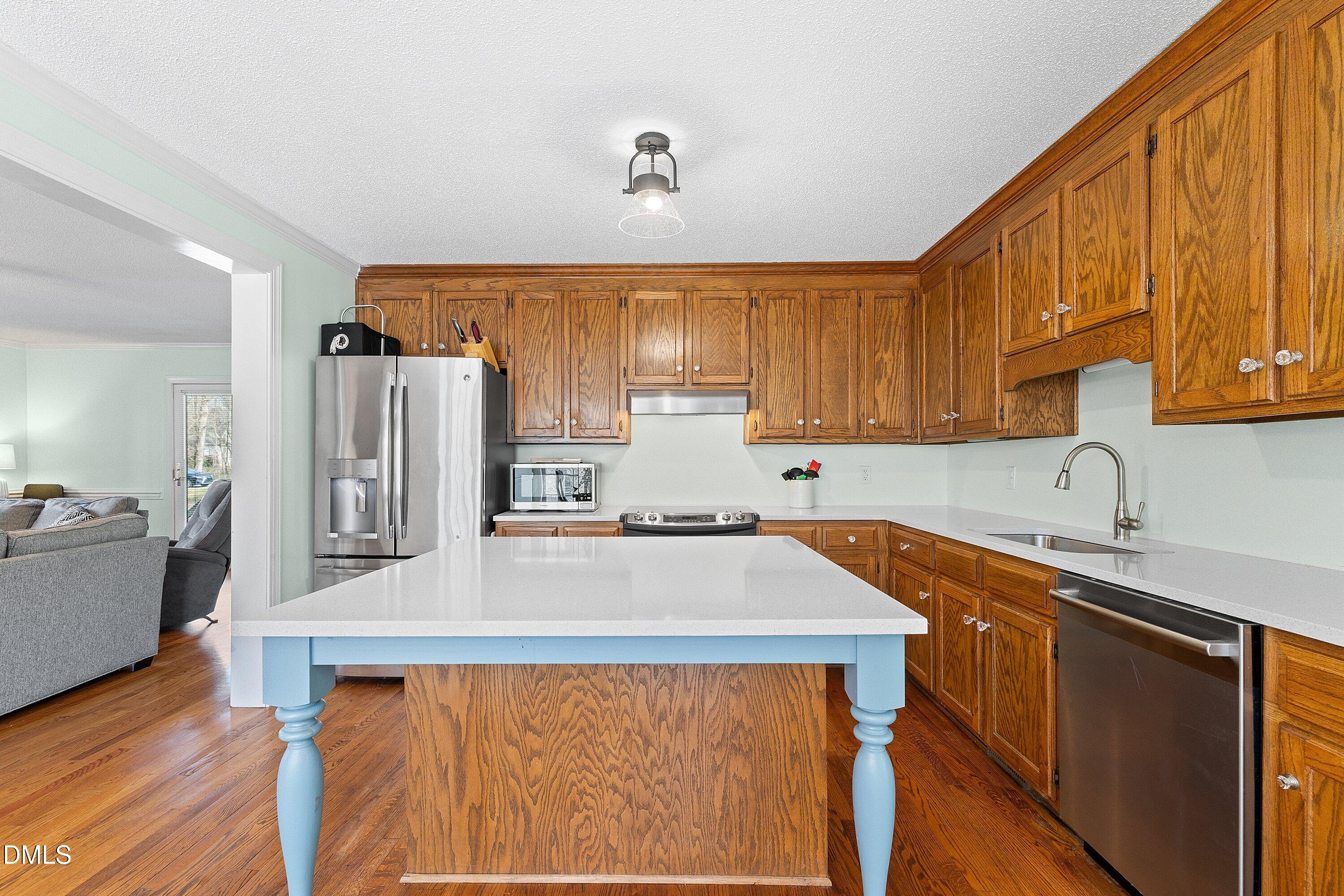 2500 Cravenridge Road Garner, NC 27529 - Photo 11 of 52 a kitchen with stainless steel appliances a refrigerator sink and cabinets