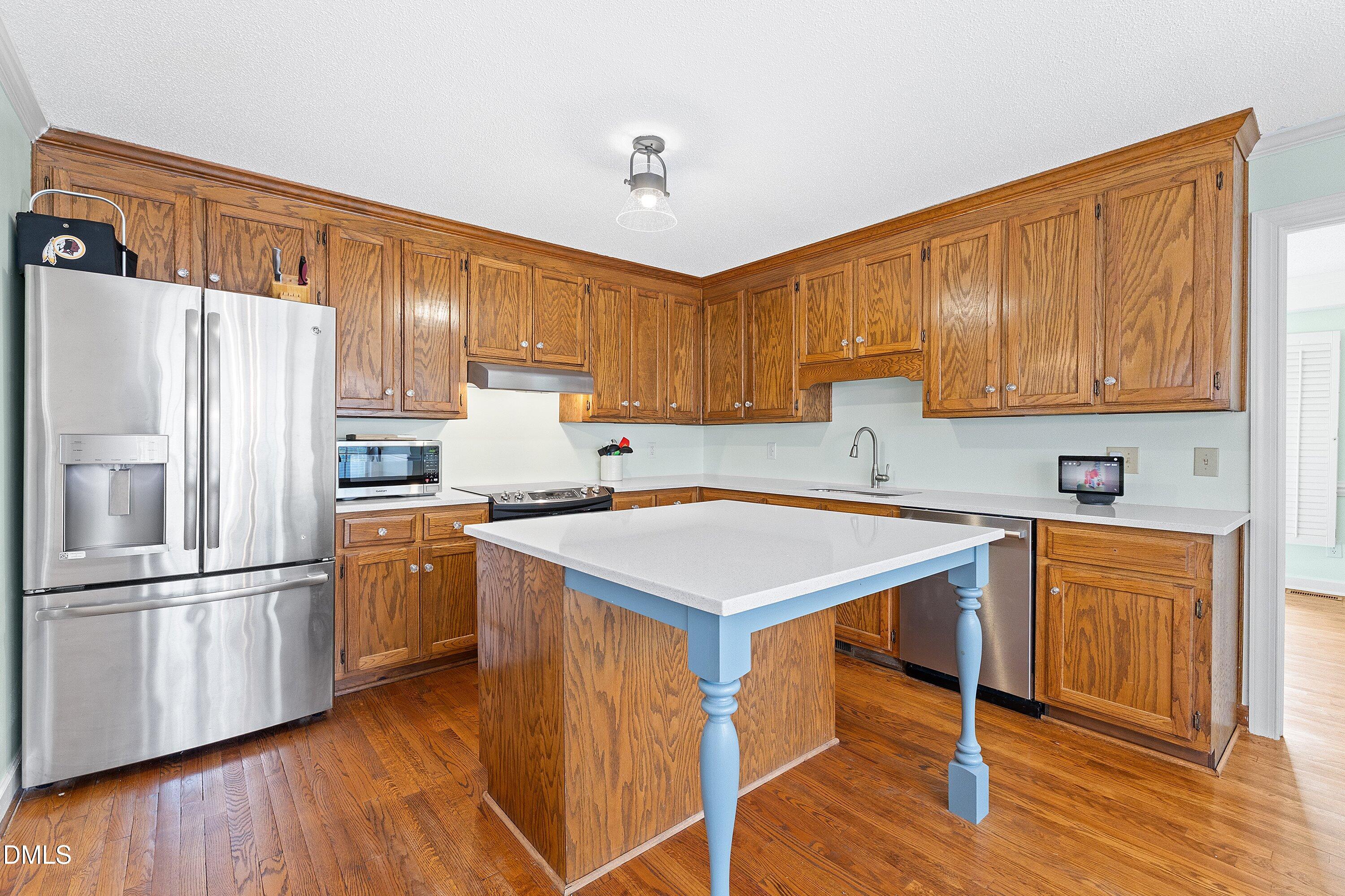 2500 Cravenridge Road Garner, NC 27529 - Photo 12 of 52 a kitchen with stainless steel appliances granite countertop a refrigerator a sink dishwasher and a stove with wooden floor