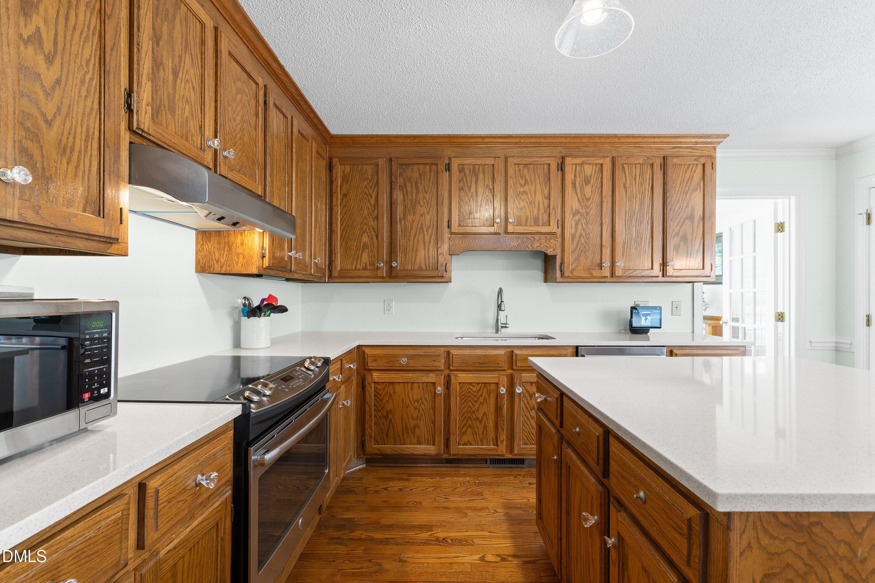 2500 Cravenridge Road Garner, NC 27529 - Photo 14 of 52 a kitchen with stainless steel appliances granite countertop a sink stove and refrigerator
