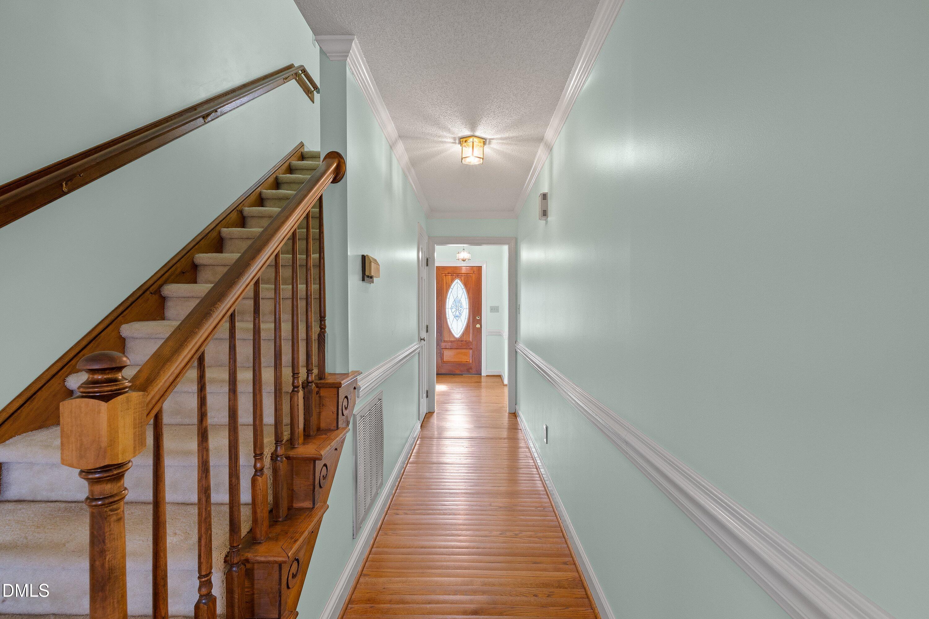 2500 Cravenridge Road Garner, NC 27529 - Photo 22 of 52 a view of a hallway with wooden floor and stairs