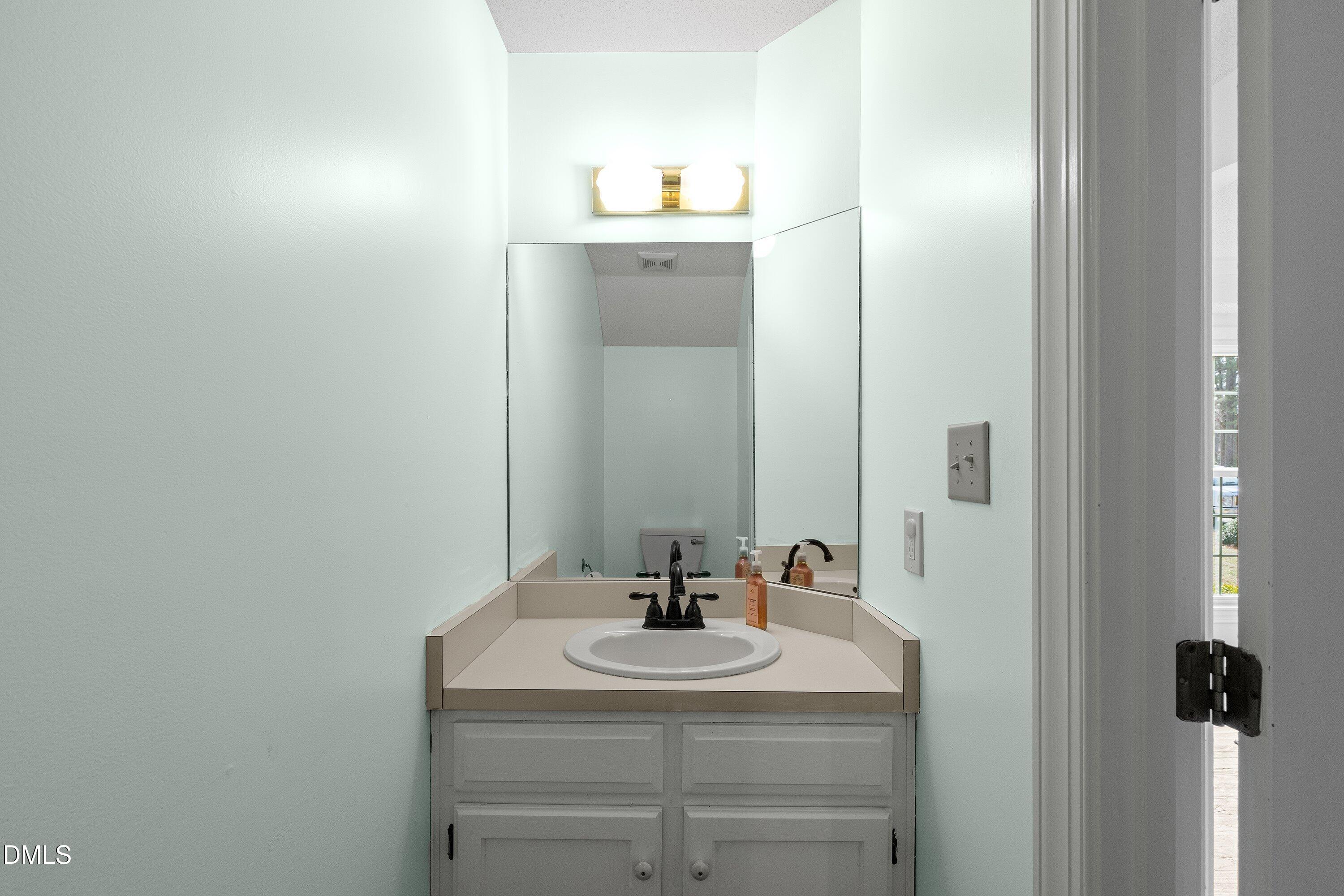 2500 Cravenridge Road Garner, NC 27529 - Photo 23 of 52 a bathroom with a sink and a mirror