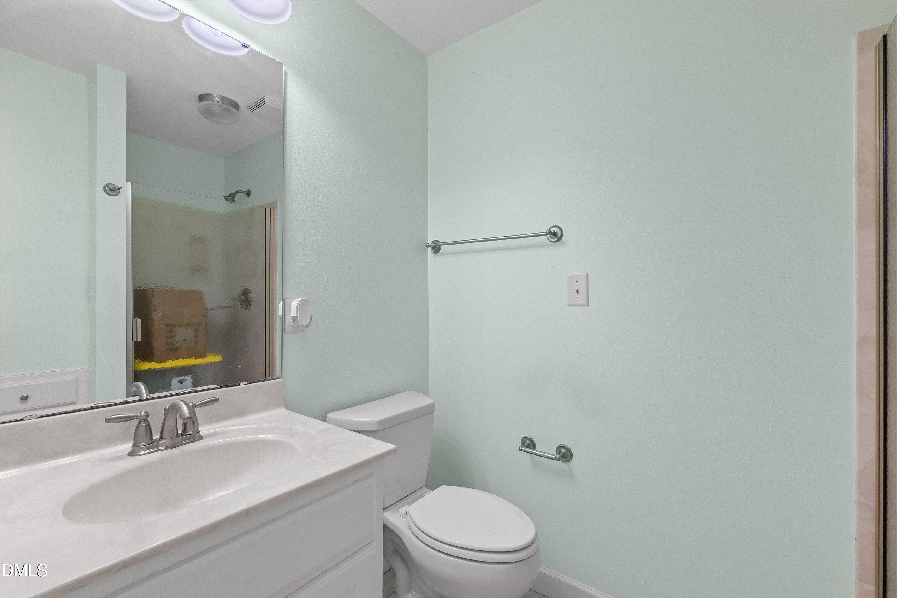 2500 Cravenridge Road Garner, NC 27529 - Photo 25 of 52 a bathroom with a sink toilet vanity and shower