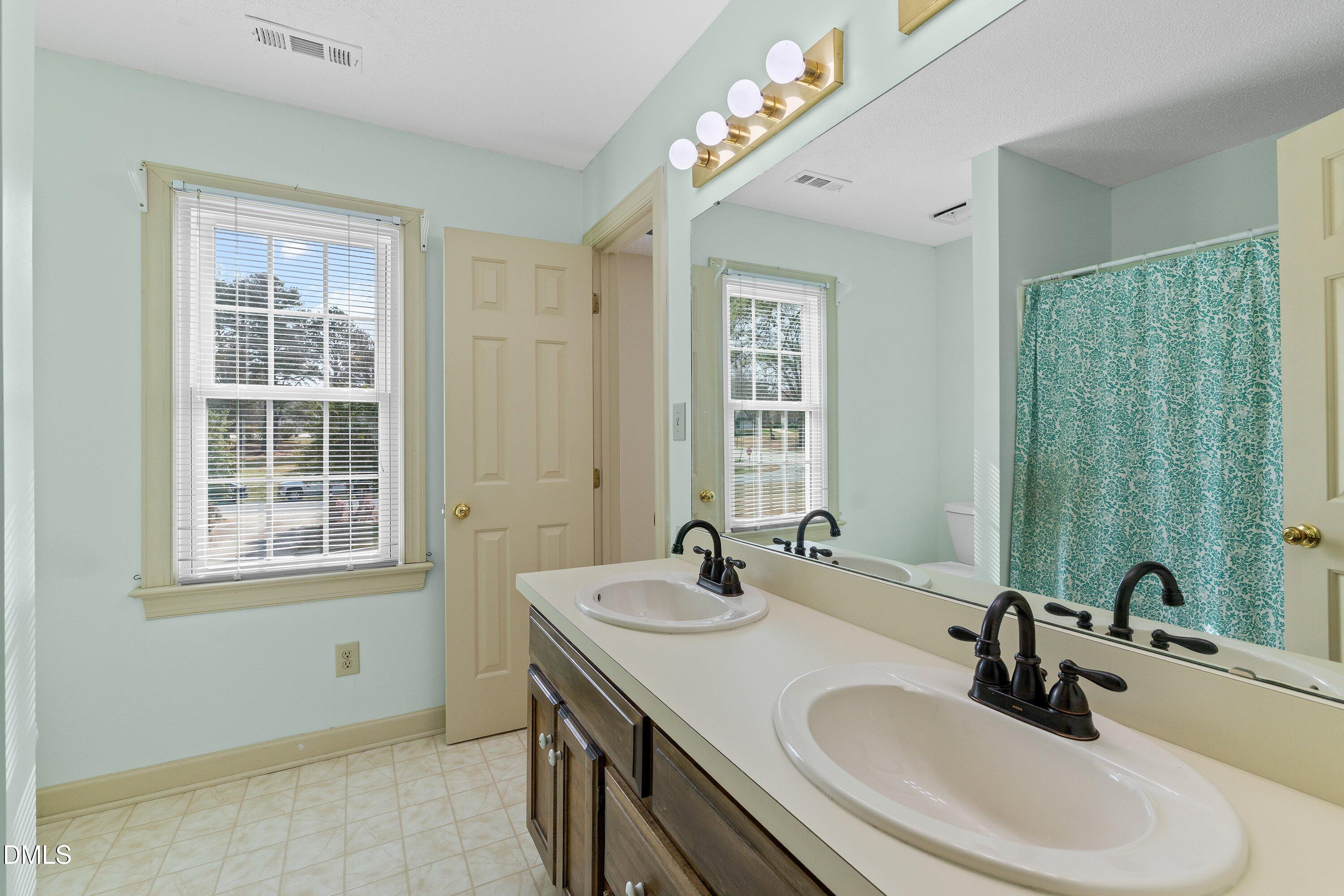 2500 Cravenridge Road Garner, NC 27529 - Photo 28 of 52 a bathroom with 2 sink and a mirror