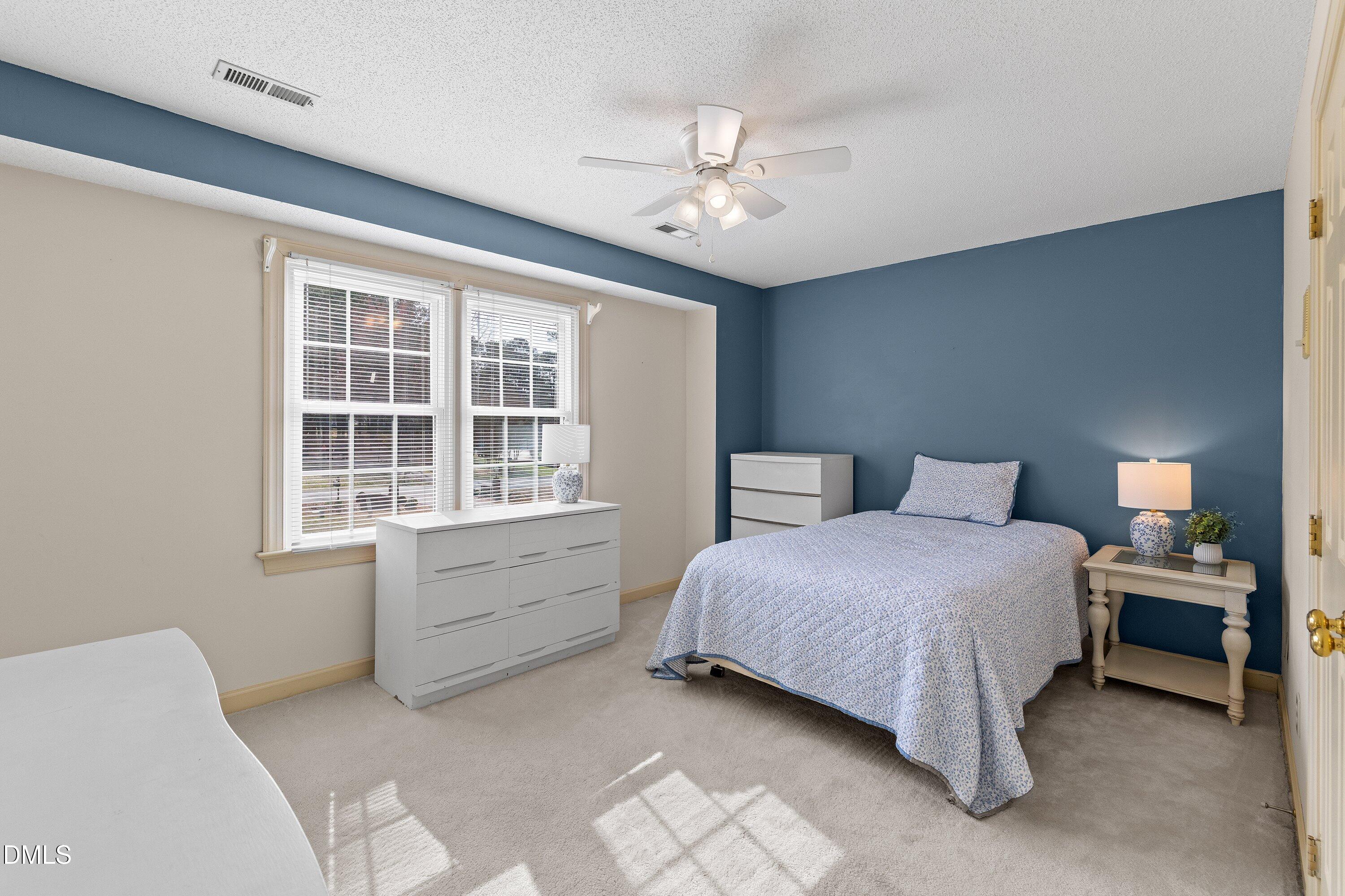 2500 Cravenridge Road Garner, NC 27529 - Photo 30 of 52 a bedroom with a bed and a chandelier