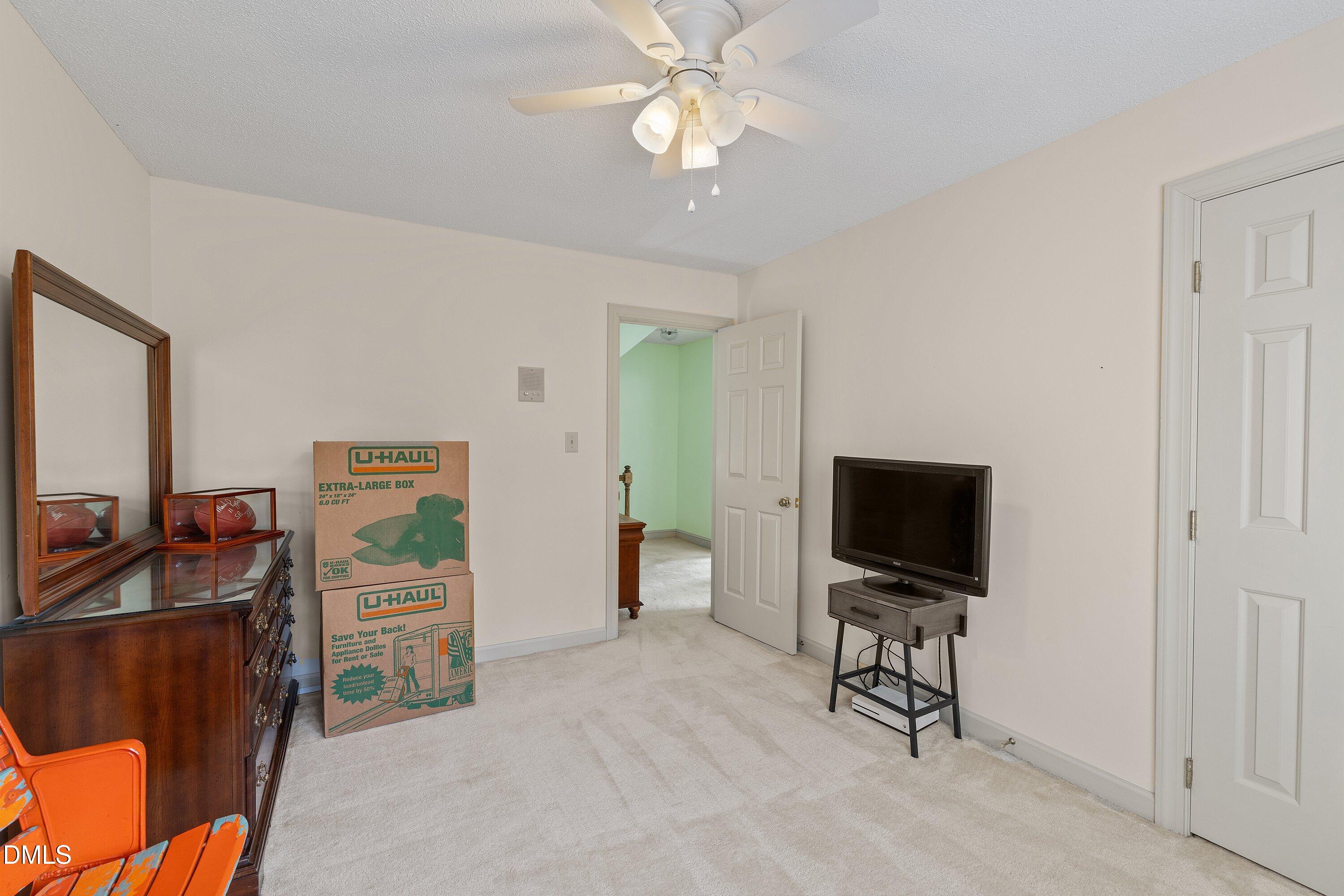 2500 Cravenridge Road Garner, NC 27529 - Photo 33 of 52 a living room with furniture and a flat screen tv