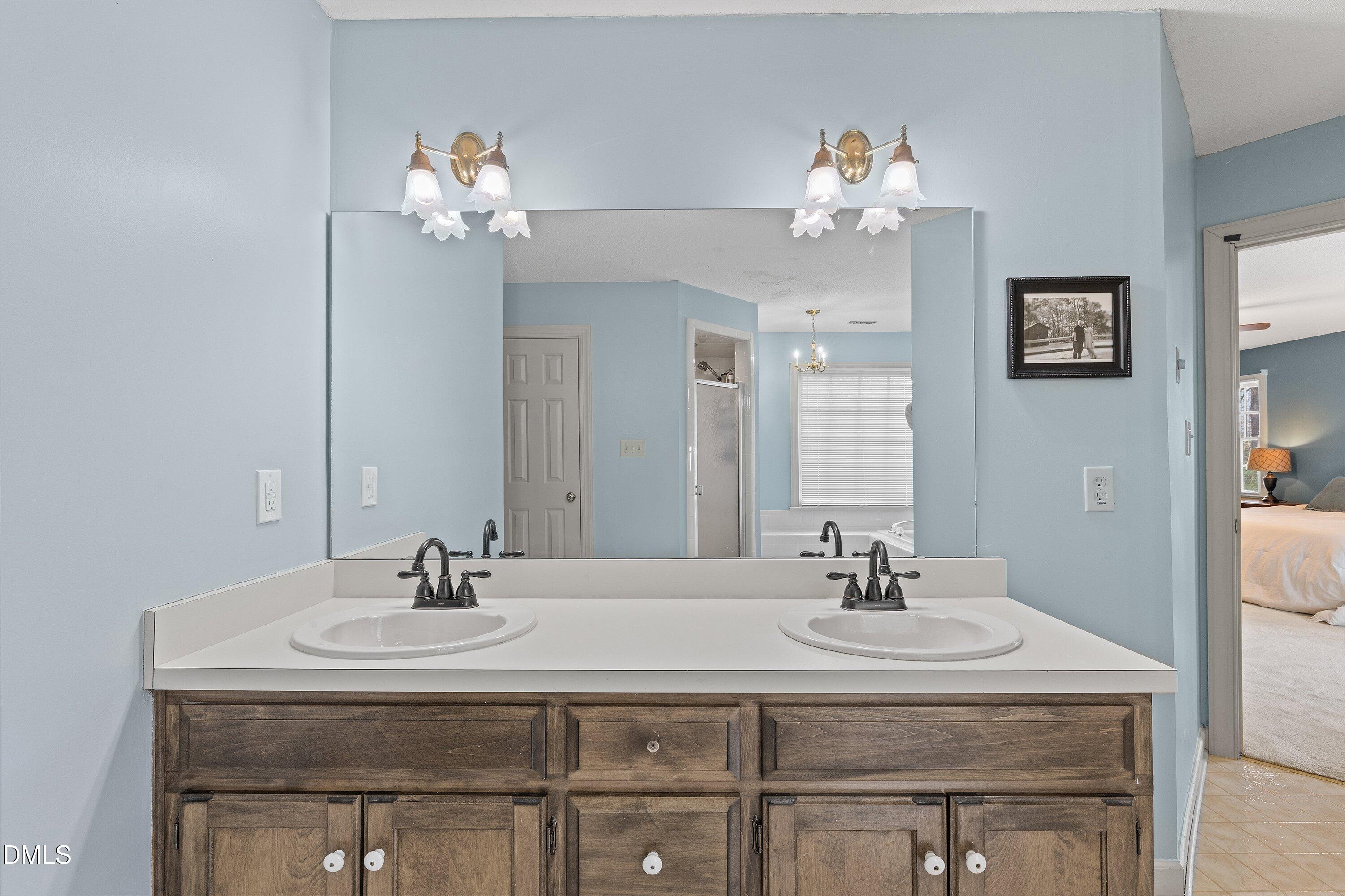 2500 Cravenridge Road Garner, NC 27529 - Photo 39 of 52 a bathroom with a sink vanity and a mirror