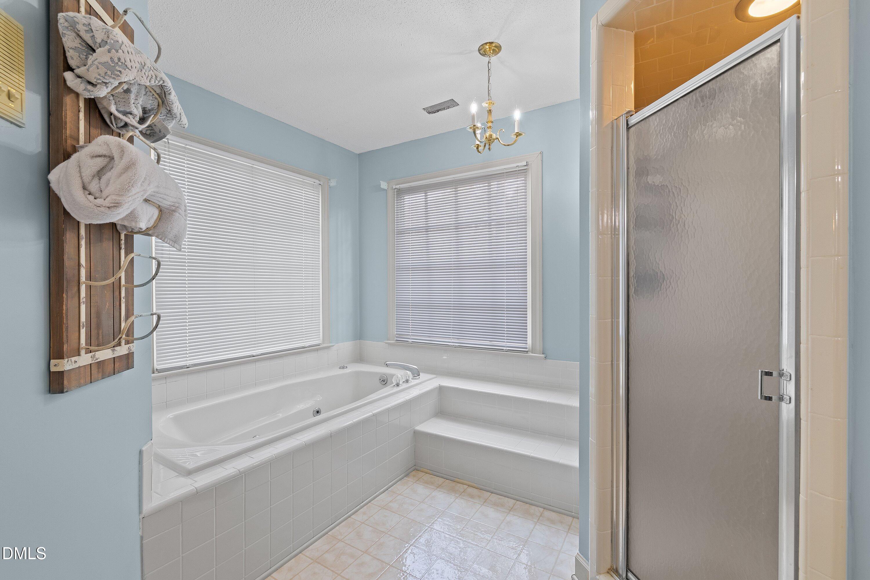 2500 Cravenridge Road Garner, NC 27529 - Photo 40 of 52 a bathroom with a bathtub a sink and a shower