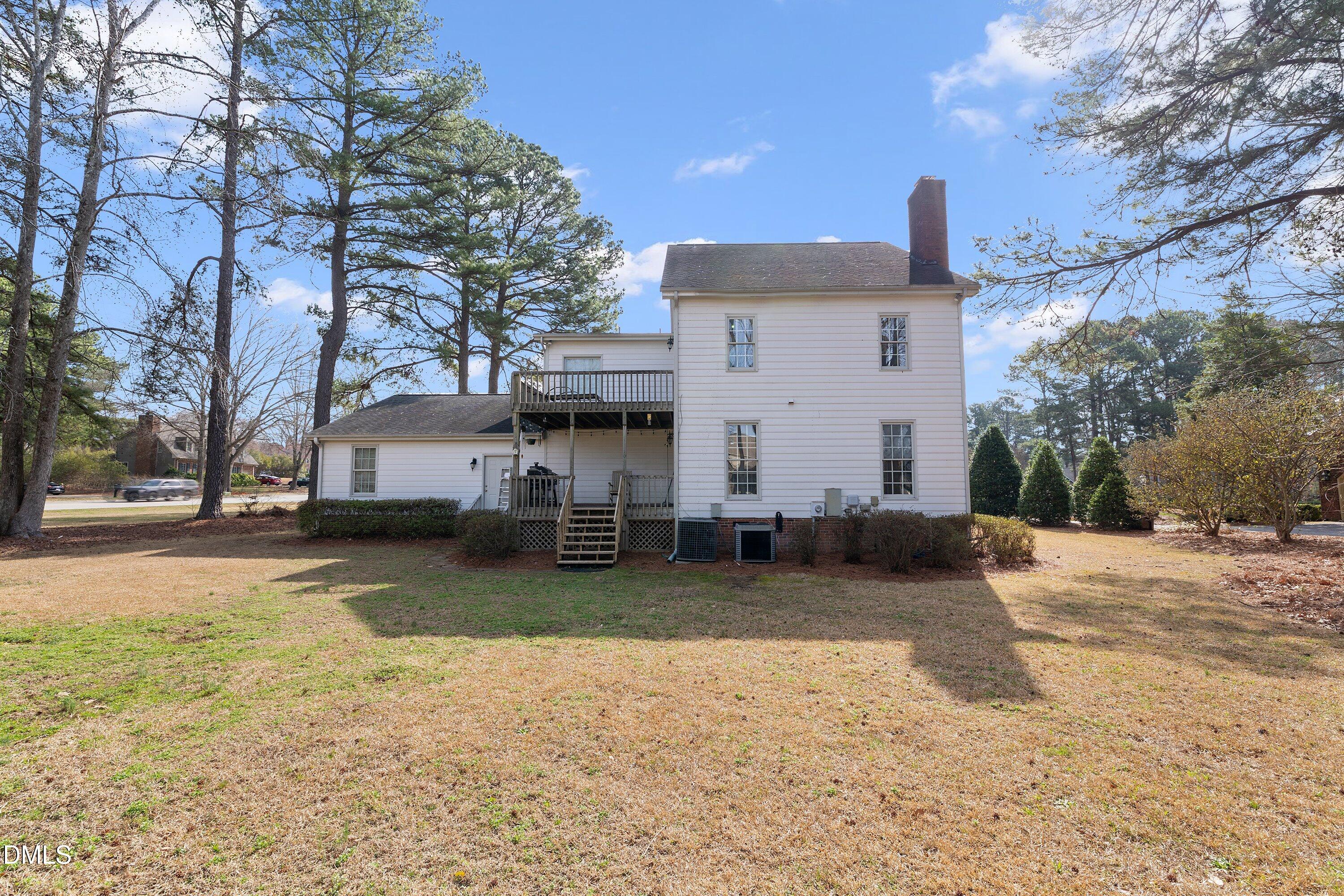 2500 Cravenridge Road Garner, NC 27529 - Photo 49 of 52 a view of a white house with a large tree and a yard