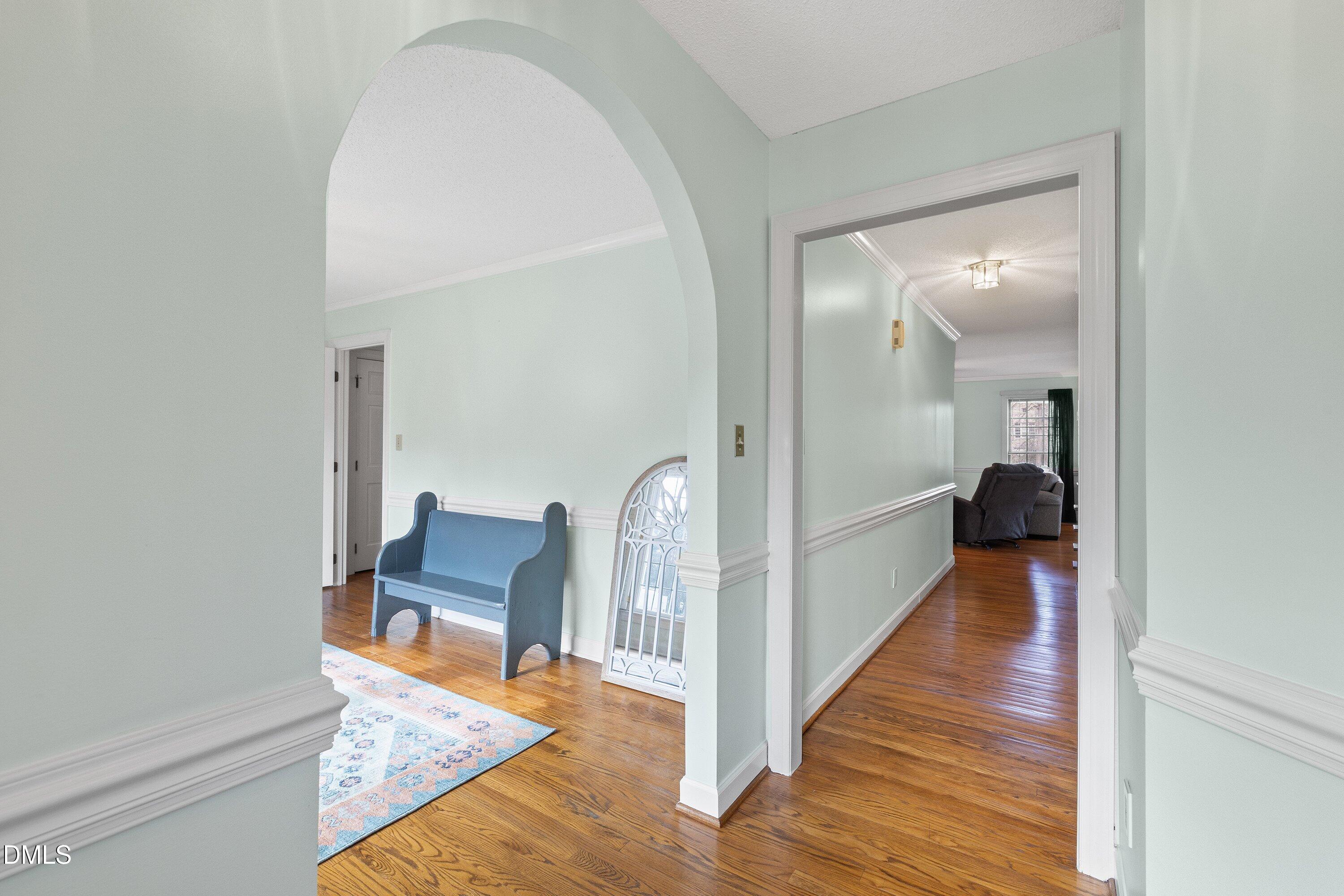 2500 Cravenridge Road Garner, NC 27529 - Photo 7 of 52 a view of a hallway and a livingroom with furniture and wooden floor