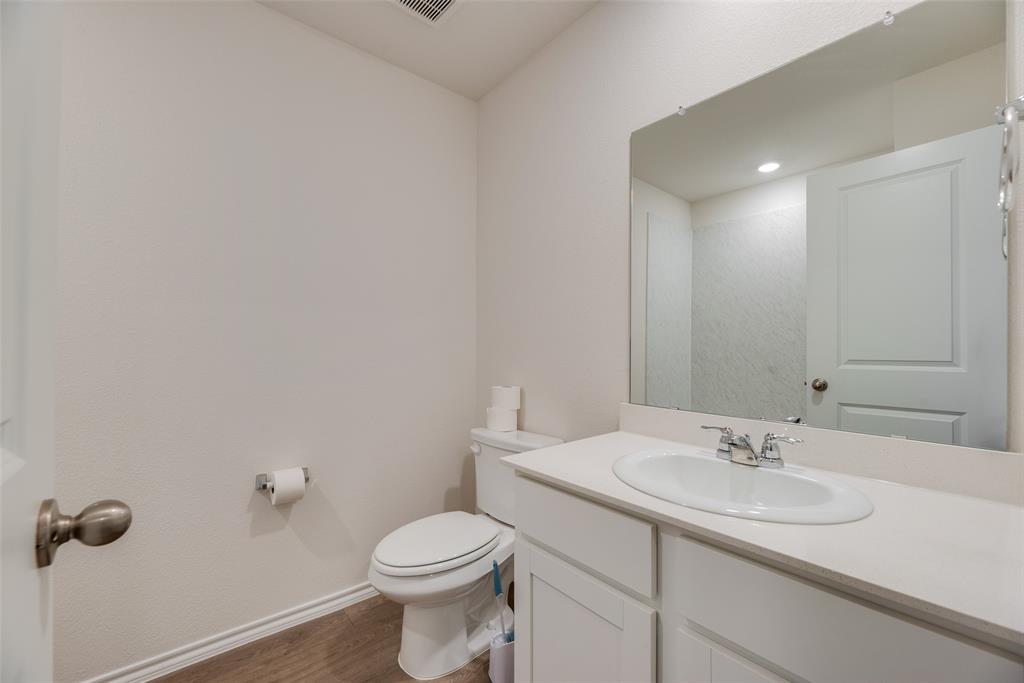 3407 Rendezvous Way Sherman, TX 75090 - Photo 11 of 17 Vanity with integrated sink, chrome faucet, and expansive mirror