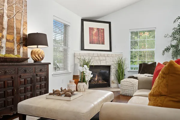 a living room with furniture and fireplace