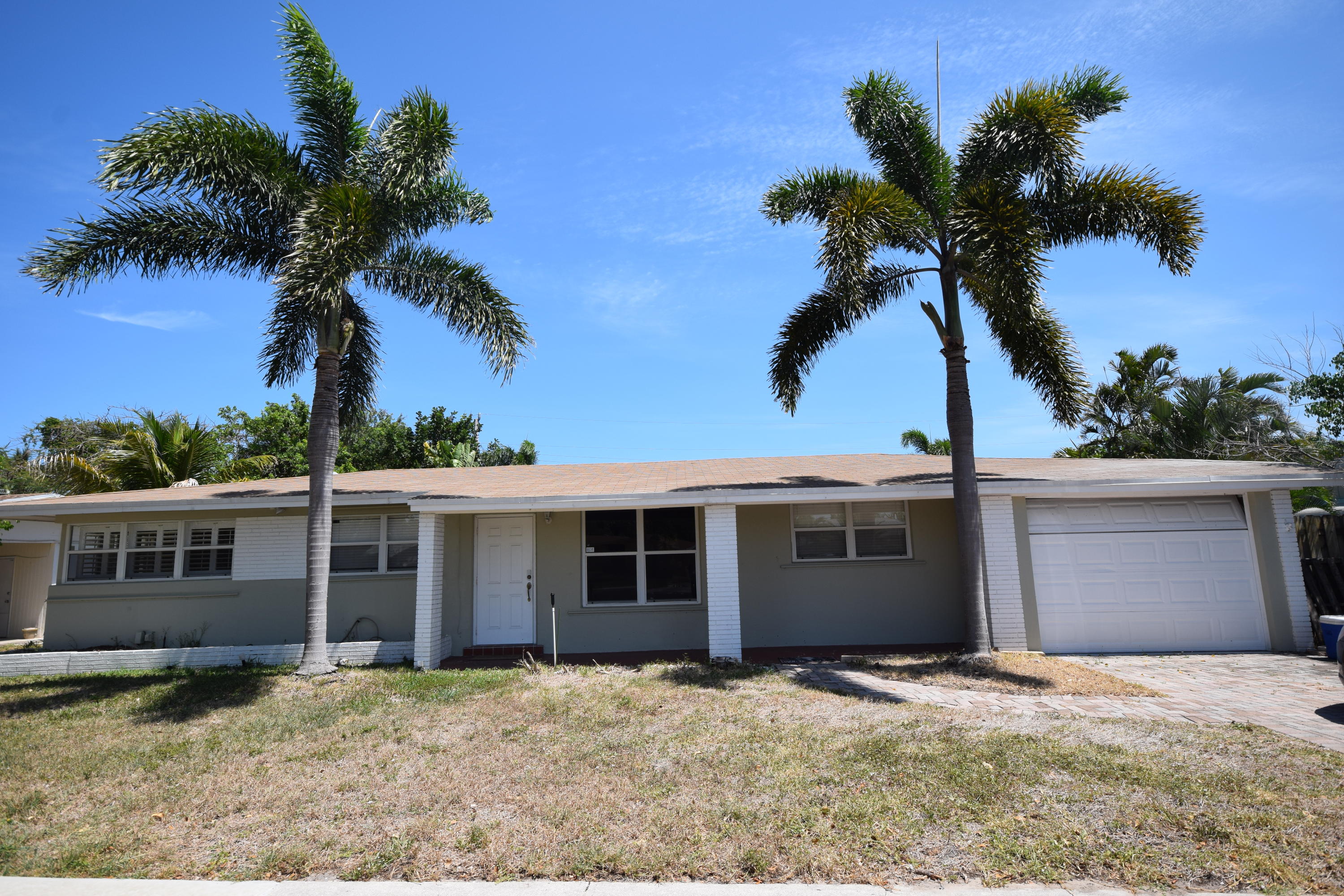 4710 Northwest 3rd Avenue Boca Raton, FL 33431 - Photo 1 of 17 a front view of a house with a garden