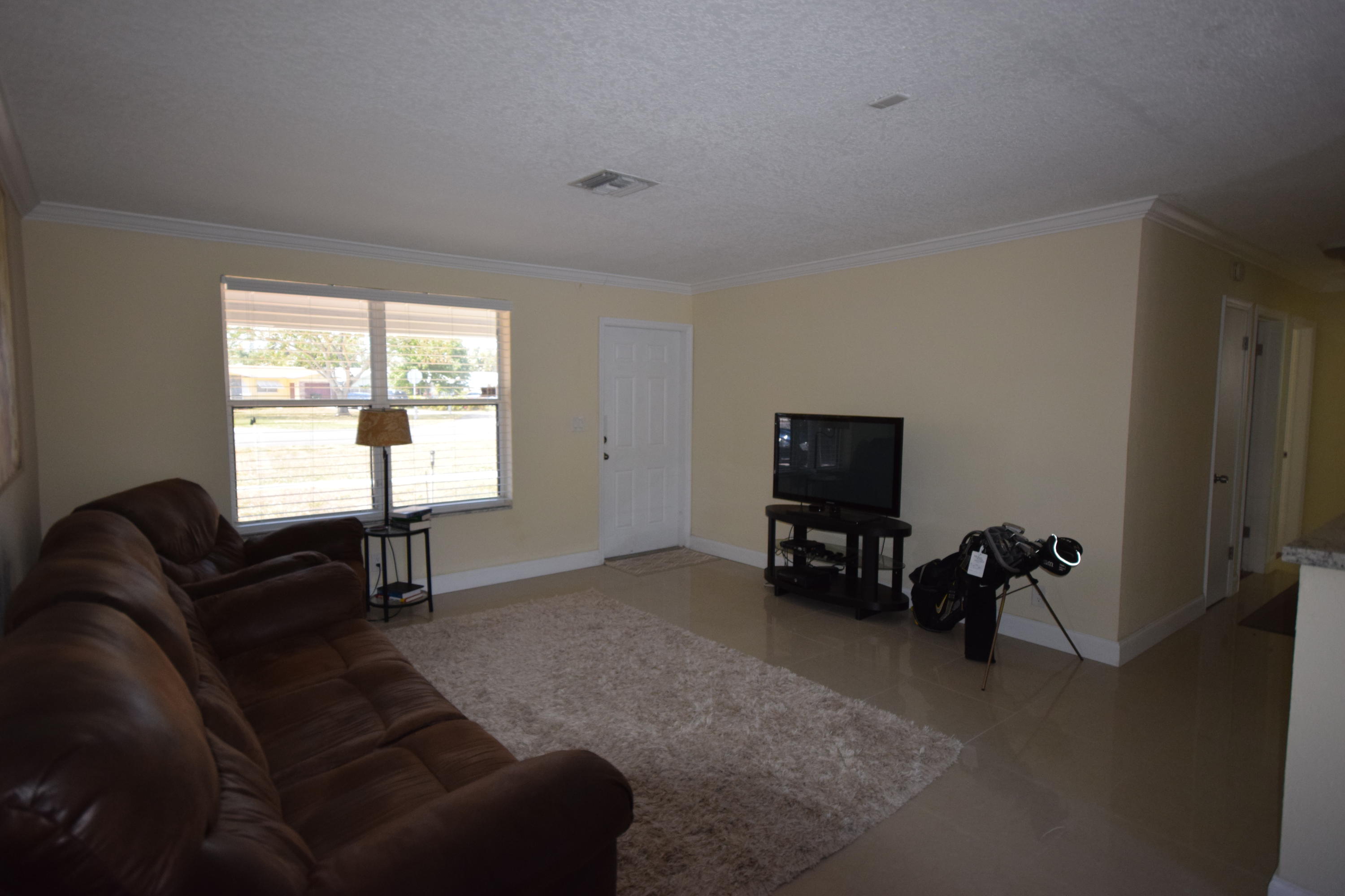 4710 Northwest 3rd Avenue Boca Raton, FL 33431 - Photo 5 of 17 a living room with furniture and a window