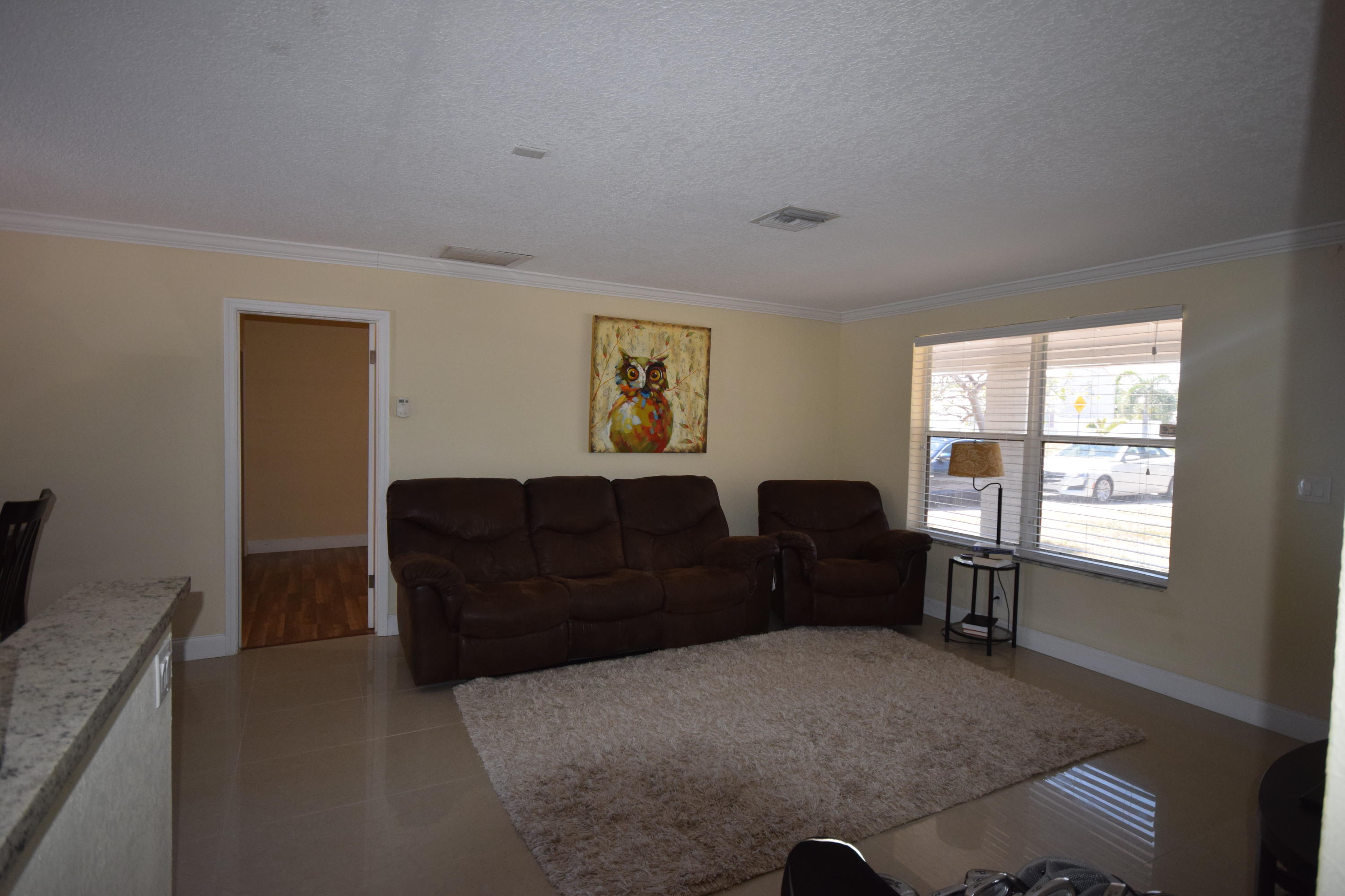 4710 Northwest 3rd Avenue Boca Raton, FL 33431 - Photo 6 of 17 a living room with furniture window and wooden floor