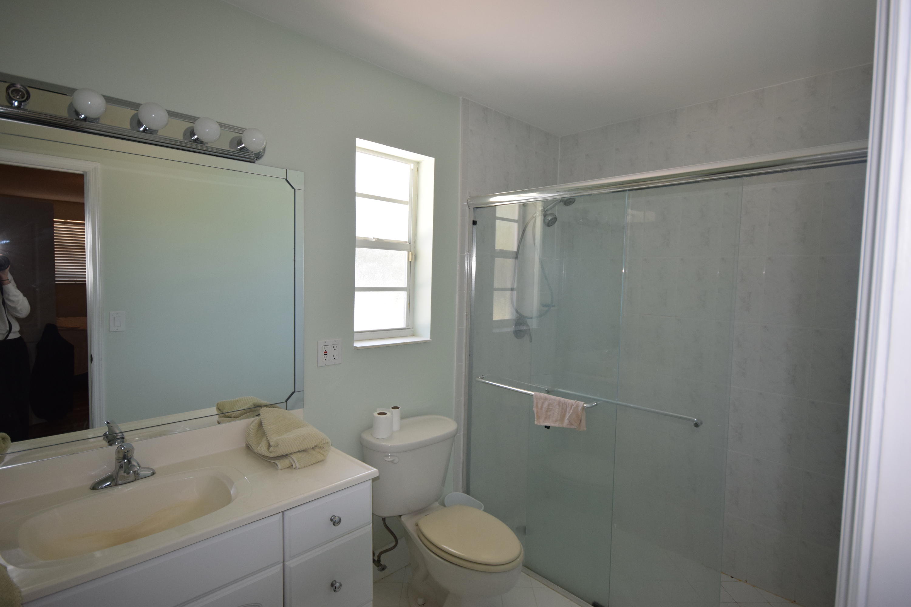 4710 Northwest 3rd Avenue Boca Raton, FL 33431 - Photo 9 of 17 a bathroom with a granite countertop sink toilet and shower