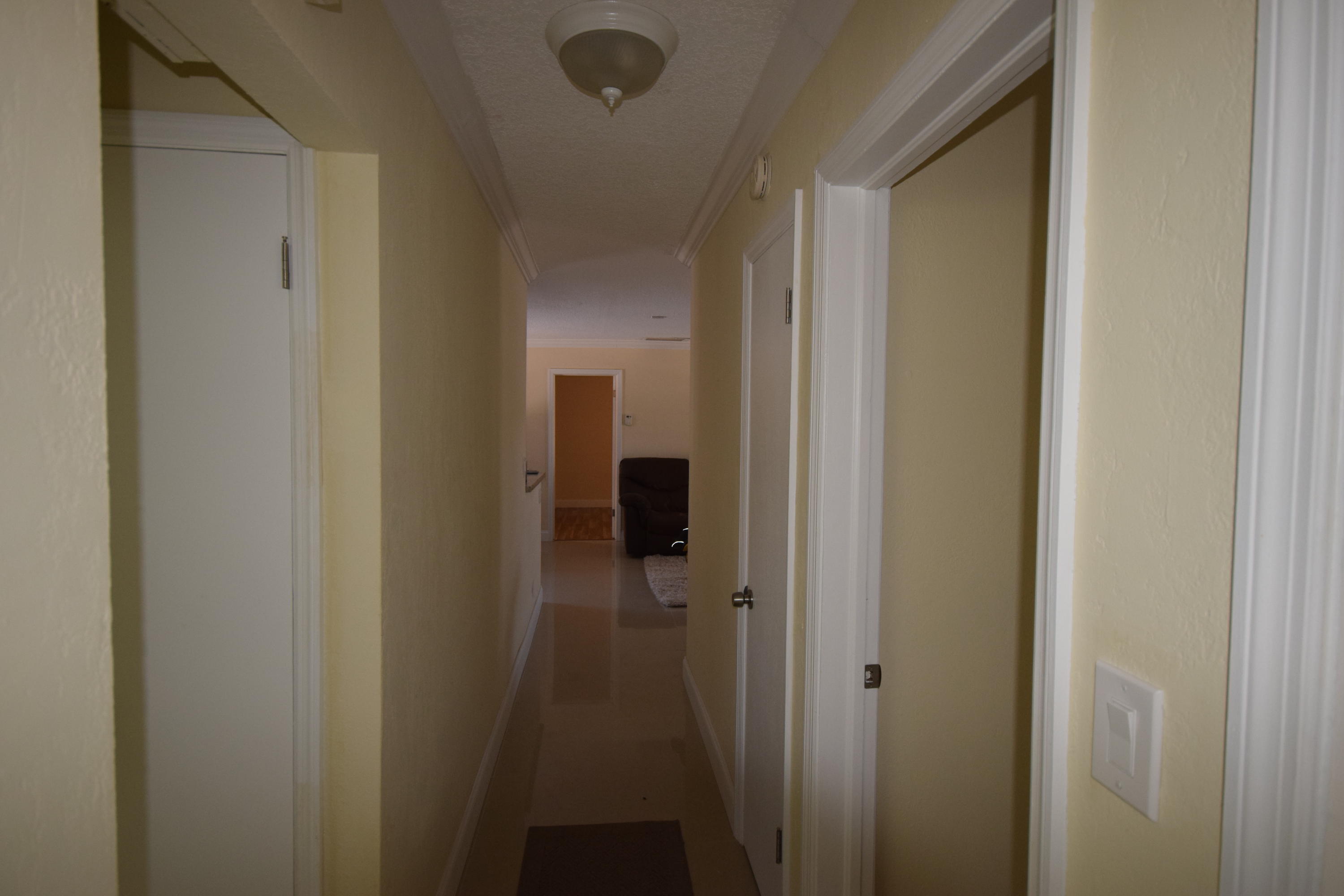 4710 Northwest 3rd Avenue Boca Raton, FL 33431 - Photo 10 of 17 a view of a bathroom from a hallway