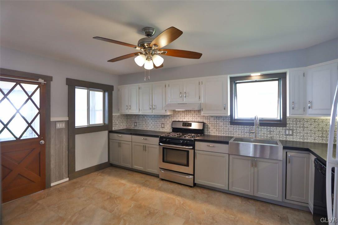 12 B Street Pen Argyl, PA 18072 - Photo 26 of 50 a kitchen with stainless steel appliances granite countertop a stove a sink dishwasher a refrigerator and white cabinets with wooden floor
