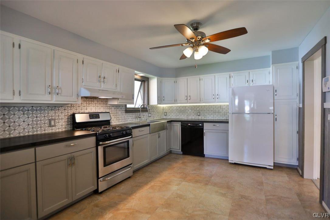 12 B Street Pen Argyl, PA 18072 - Photo 34 of 50 a kitchen with stainless steel appliances granite countertop a sink a stove and cabinets