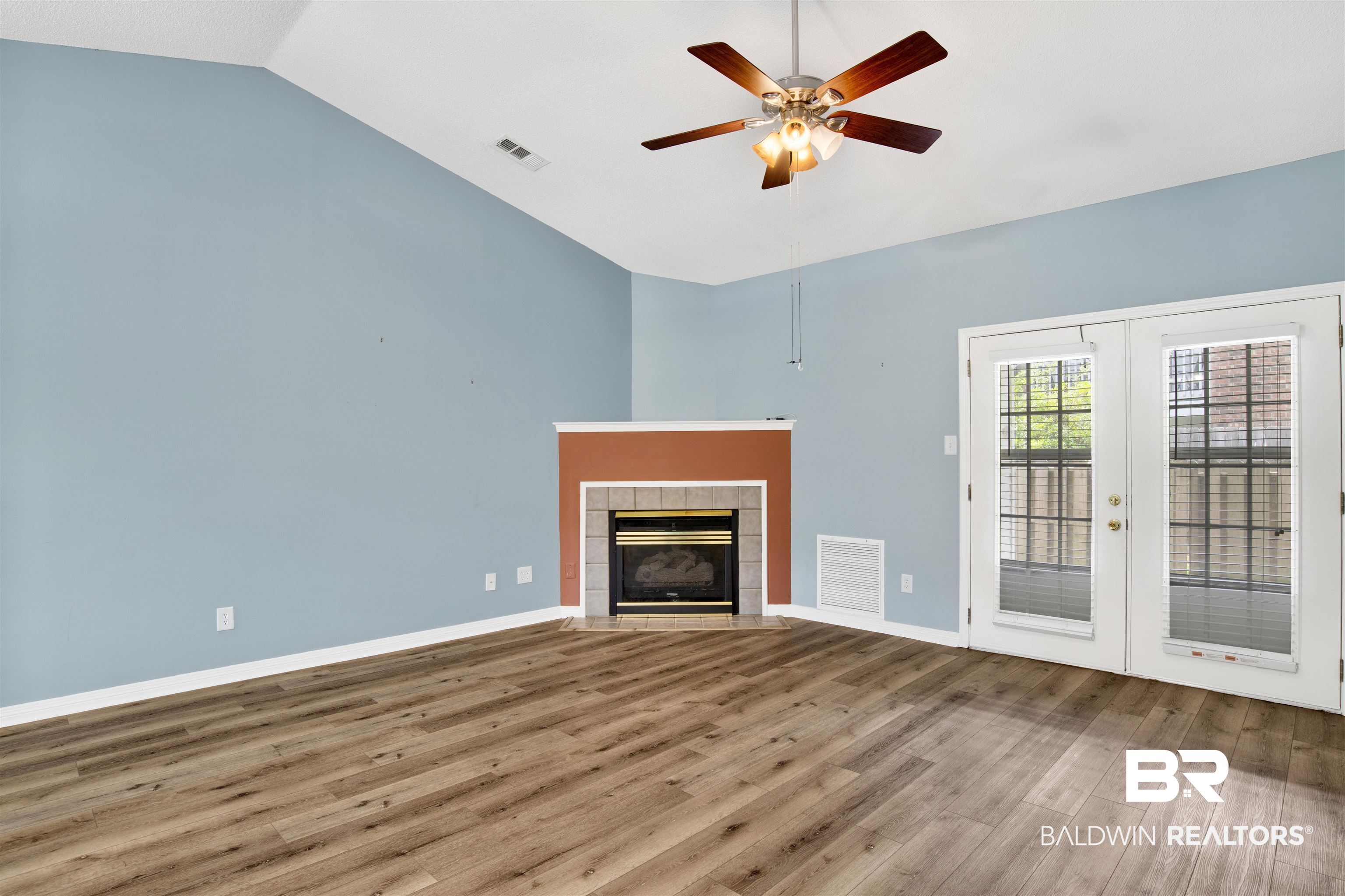 1258 Sutton Court, Unit 4 Mobile, AL 36609 - Photo 3 of 19 Unfurnished living room featuring french doors, ceiling fan, visible vents, and wood finished floors