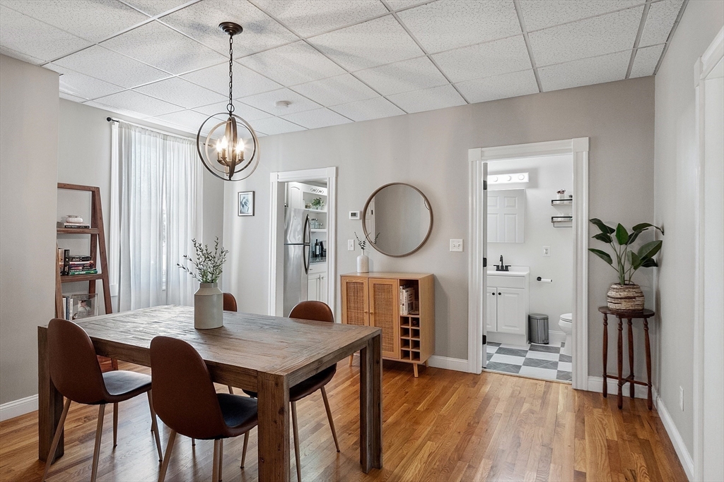 3 Park Street, Unit 1 Danvers, MA 01923 - Photo 1 of 25 a view of a dining room with furniture a chandelier and wooden floor