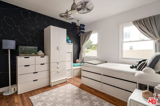 a bedroom with a bed dresser and a window