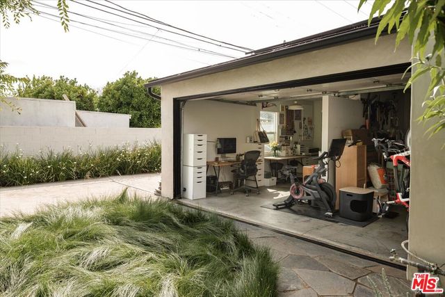 a view of a house with potted plants in front of it