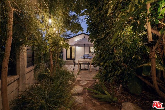 a backyard of a house with table and chairs