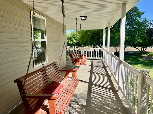 812 East Bates Cyn Road Tooele, UT 84074 - Photo 6 of 144 Covered porch with light-toned siding, white trim, and a white railing system