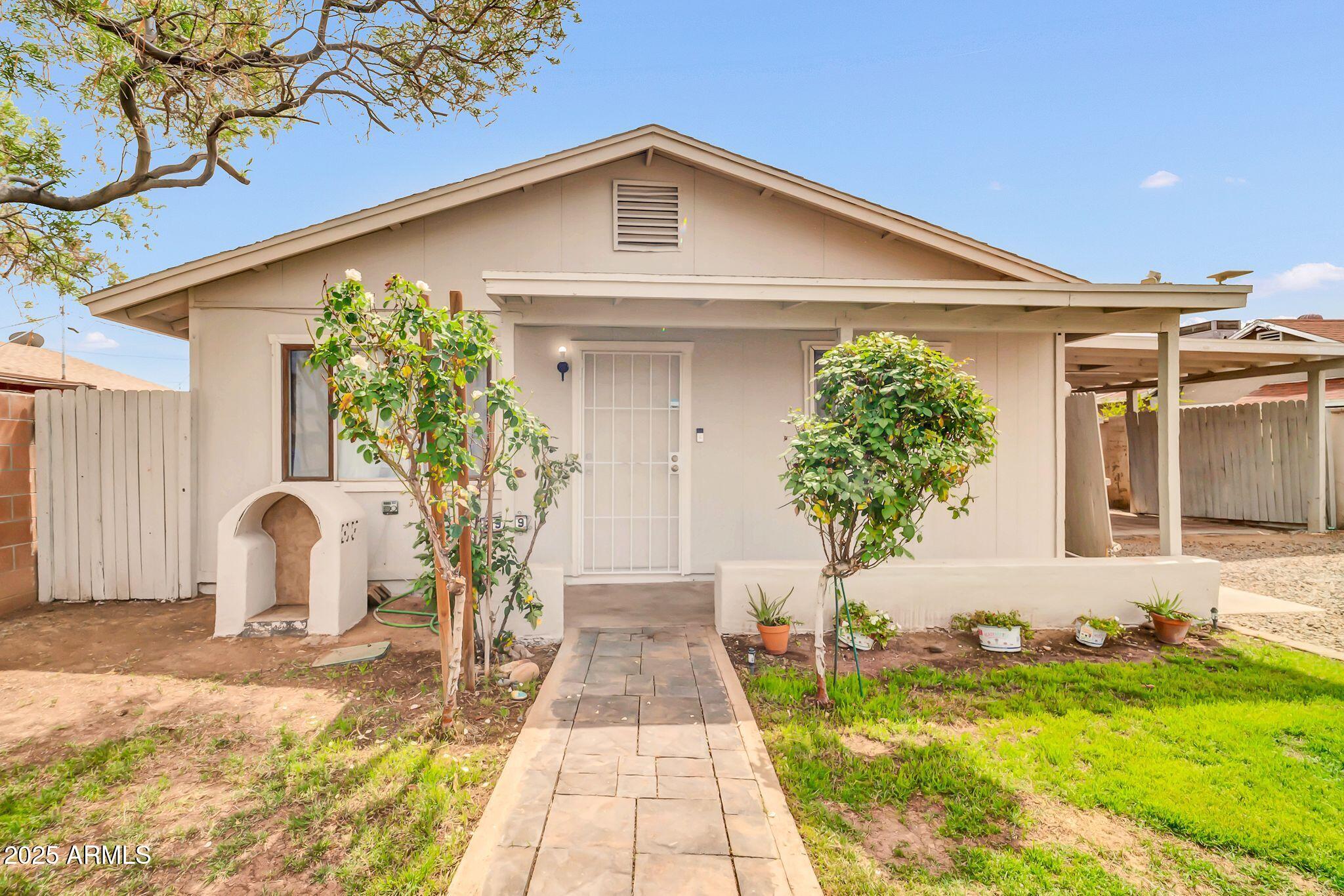 2929 West Granada Road Phoenix, AZ 85009 - Photo 1 of 28 a front view of a house with garden